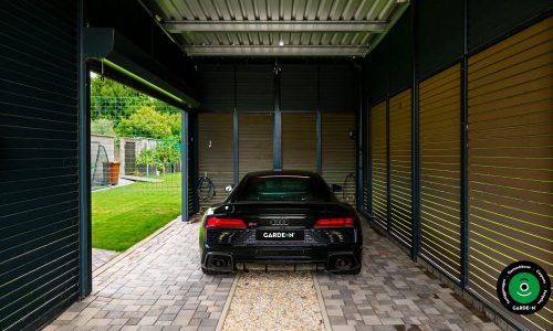Rückansicht eines Autos in einem modernen Carport mit Lamellen.