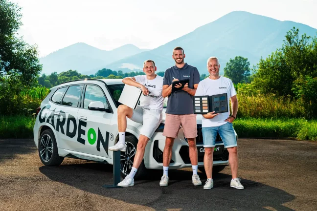 GARDEON-Handelsvertreter mit Farbmusterbuch am Firmen-BMW.